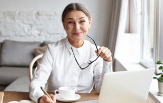 professional woman working from home writing notes