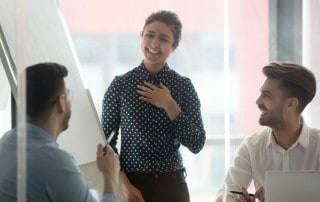Woman in a business meeting presenting herself in front of two colleagues