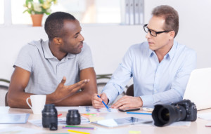 Two men sharing an in-person coaching session