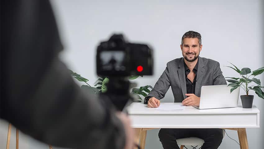 man recording corporate training session on camera