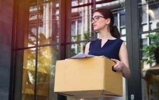 ragazze che abbandona il luogo lavorativo con una scatola delle sue cose