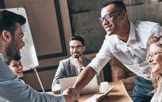 Professionals welcoming new remote teammate during onboarding