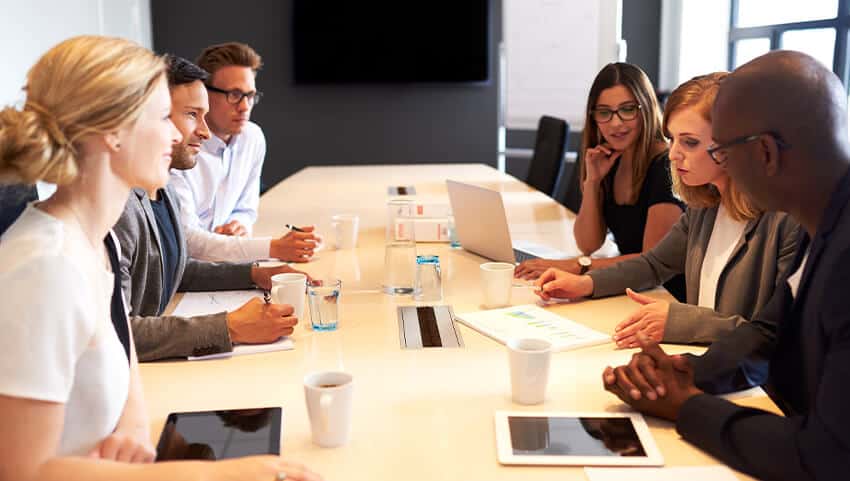 a team sitting around a table 