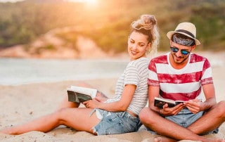giovani hr leggono libro su una spiaggia al sole