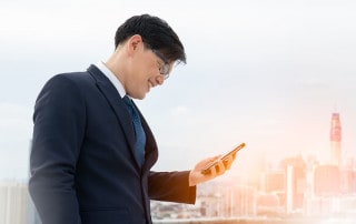 man looking at digital trends on his cell phone