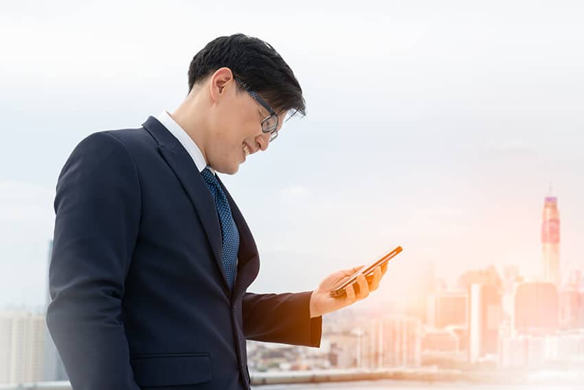 man looking at digital trends on his cell phone