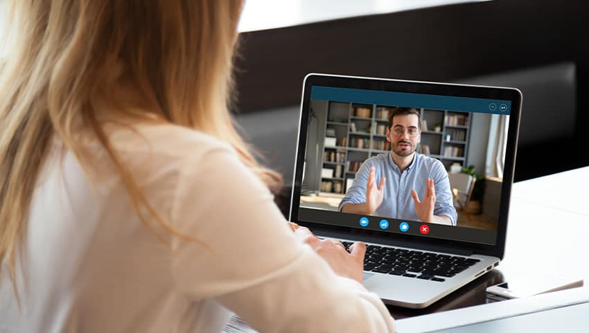 woman completing a video-based training on a laptop