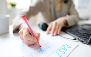 Personalized English Course with young woman taking notes